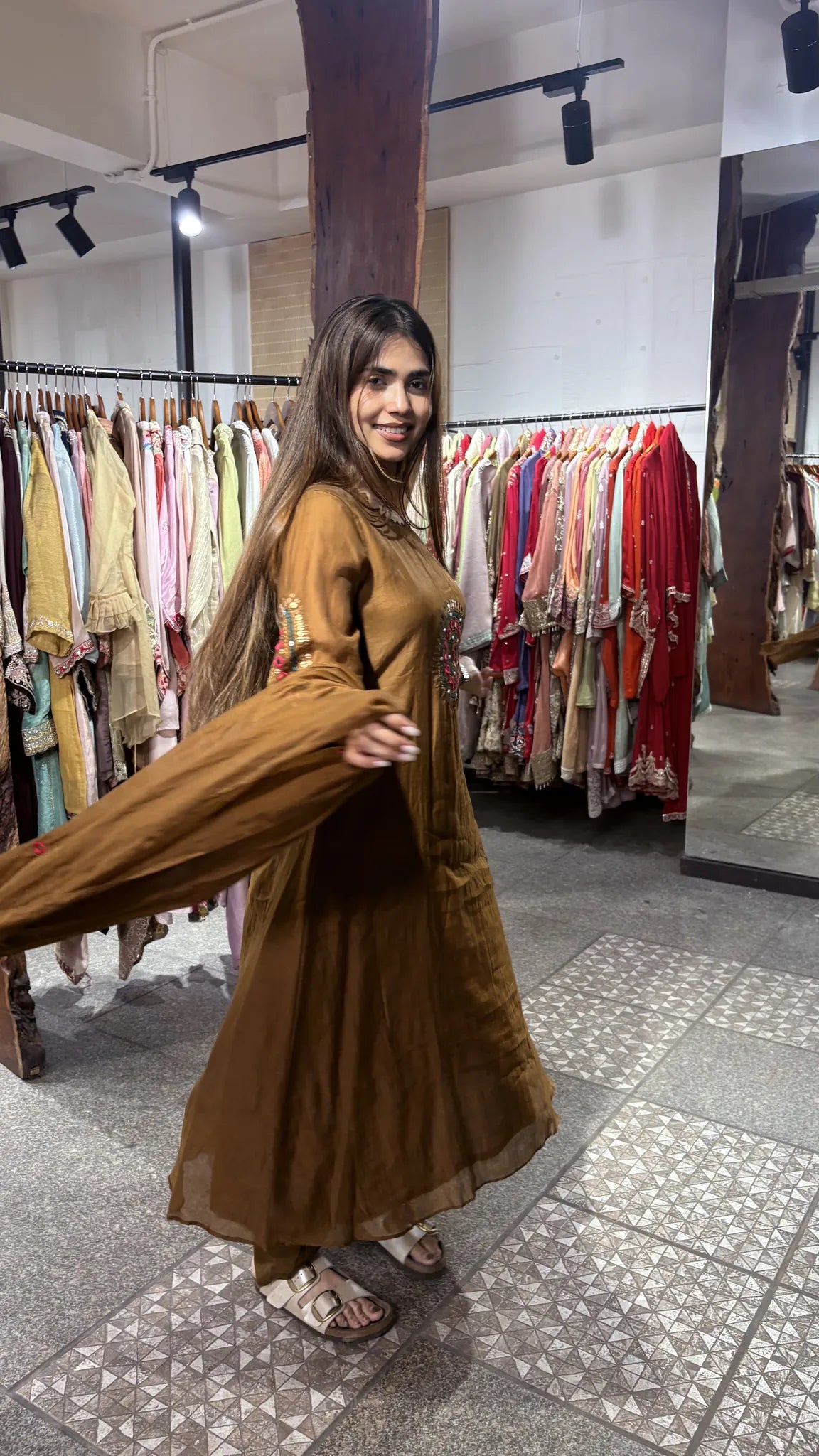 The brown dupatta swung out in motion, showing the soft fall of the mul chanderi against the A-line kurti and matching pant.
