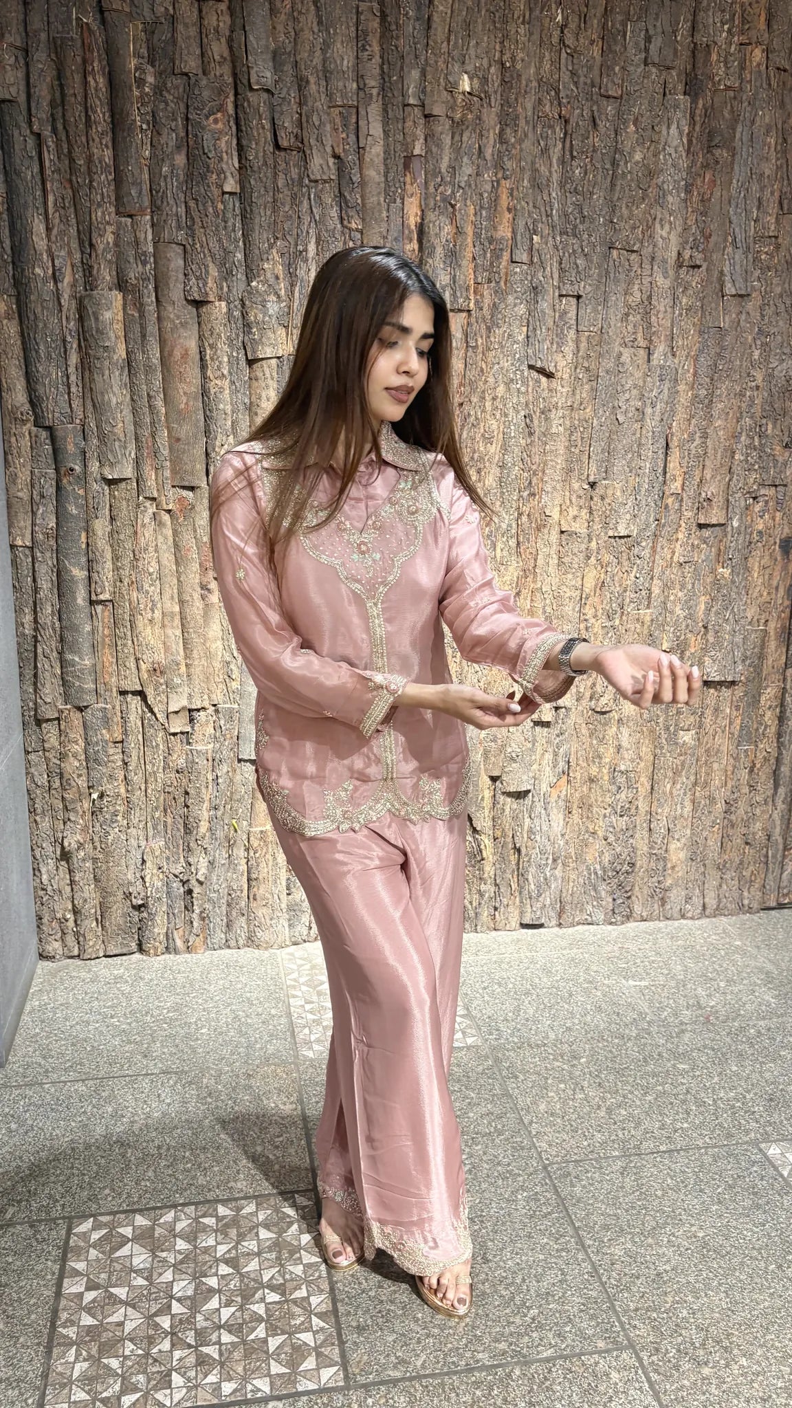 Baby pink chinnon co-ord set seen in movement, showing the fluid drape of the satin through the shirt and the plazo.