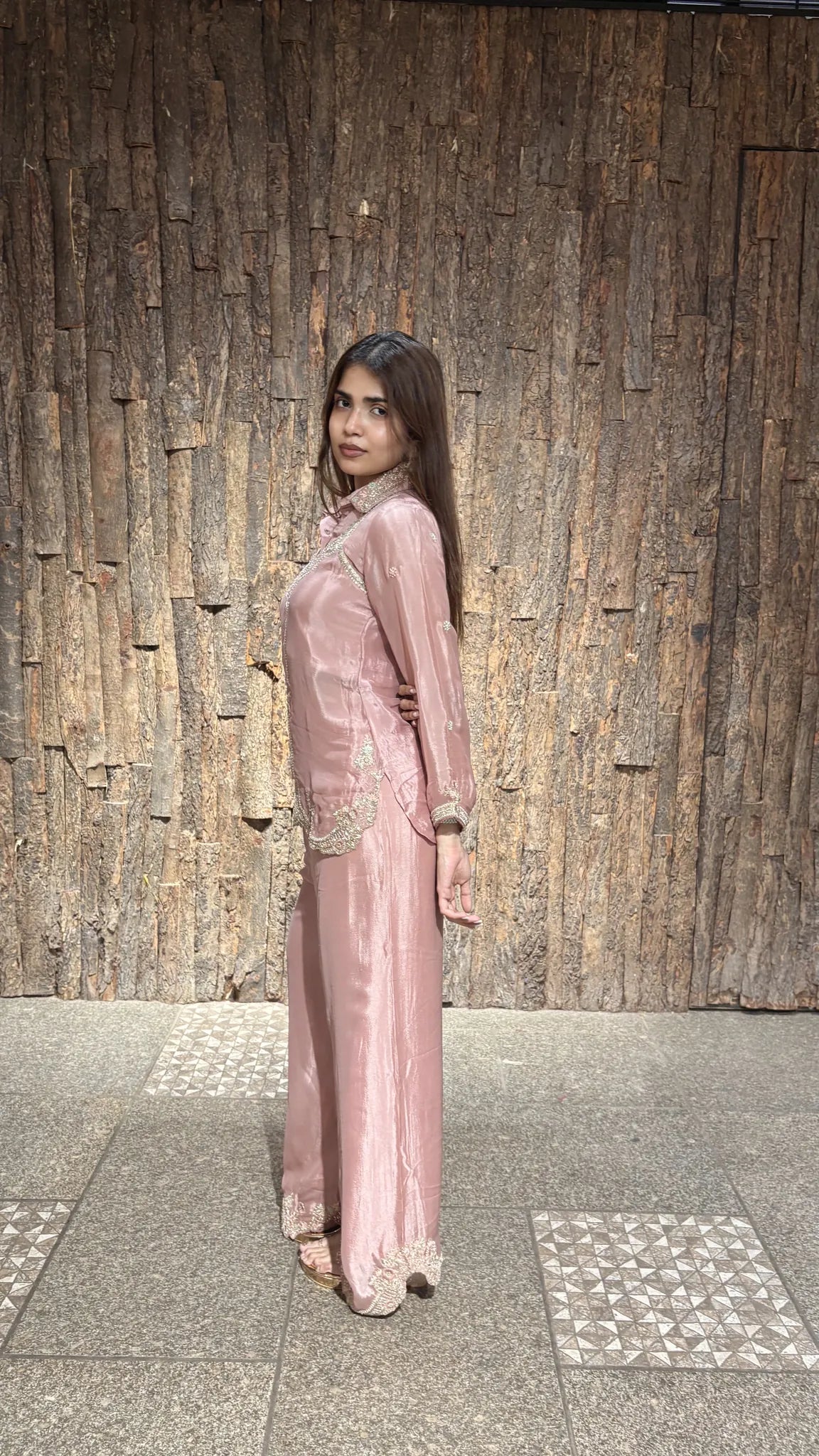 Three-quarter view of the baby pink co-ord, with embroidery across the shirt front and scalloped lace at the hem.