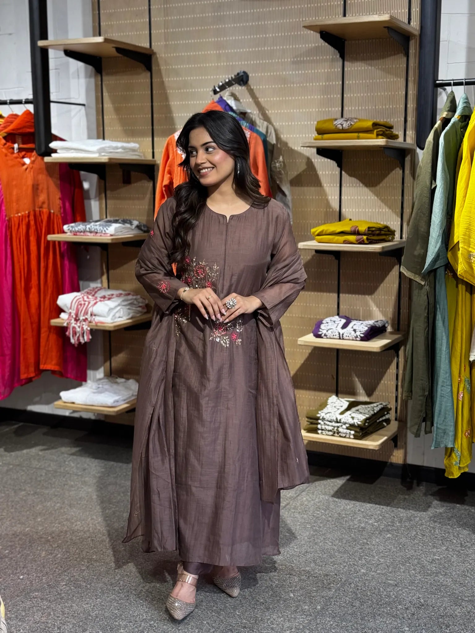 Full-length mauve set, model smiling with hands at her waist, the sheer dupatta falling in soft folds to the hem.