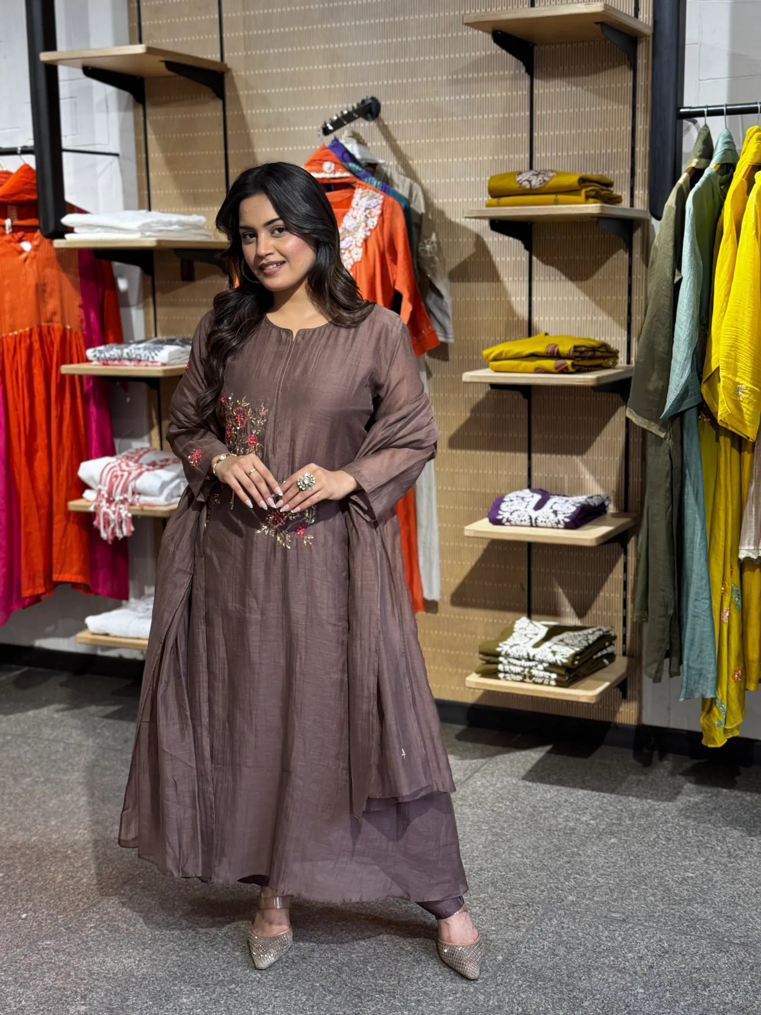 Model in cocoa-mauve chanderi, embroidered floral sprigs scattered across the front panel of the straight-cut kurta.