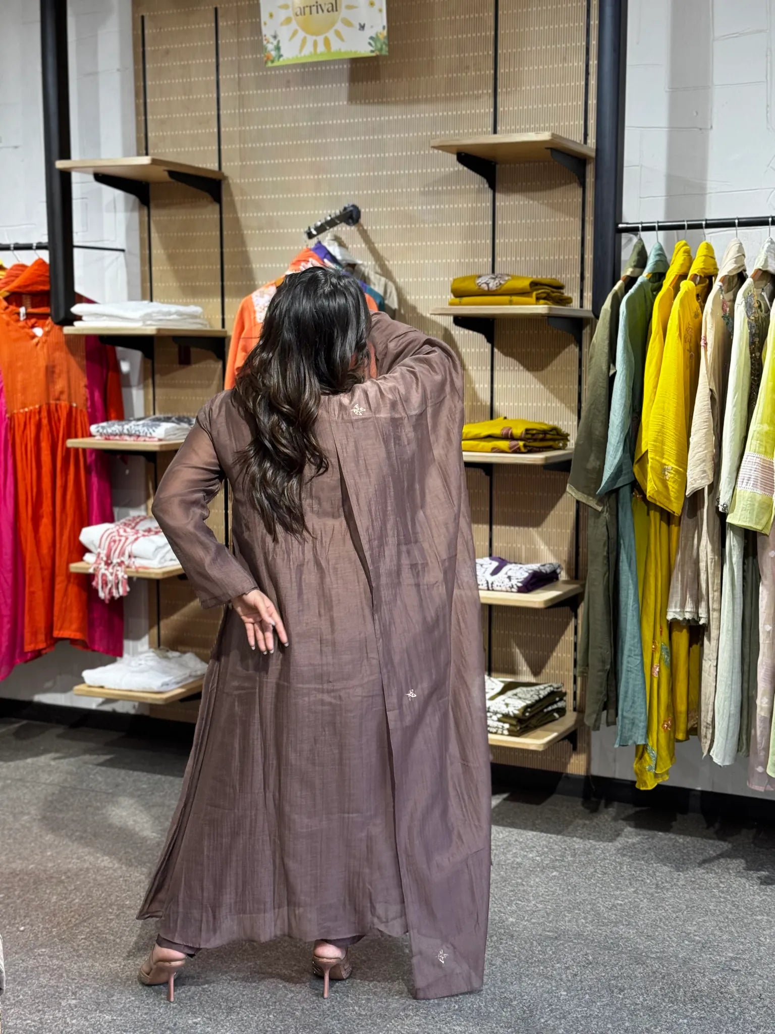 Rear view in mauve chanderi, dupatta trailing down the back over the long straight kurta and matching trousers.