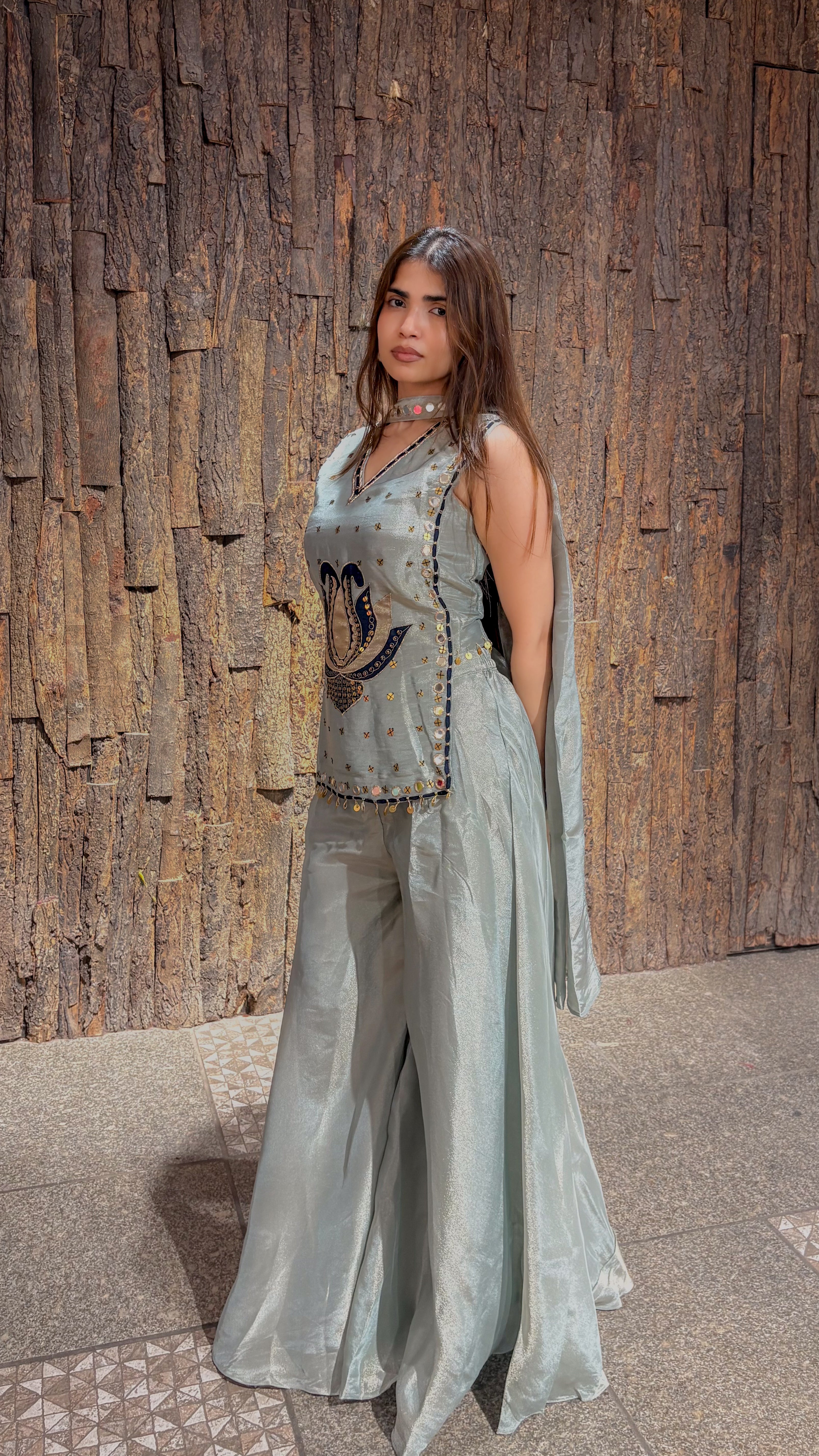 Side view of the mint green tissue plazo set, the cape-style panels falling loose beside the wide-legged tissue trousers.