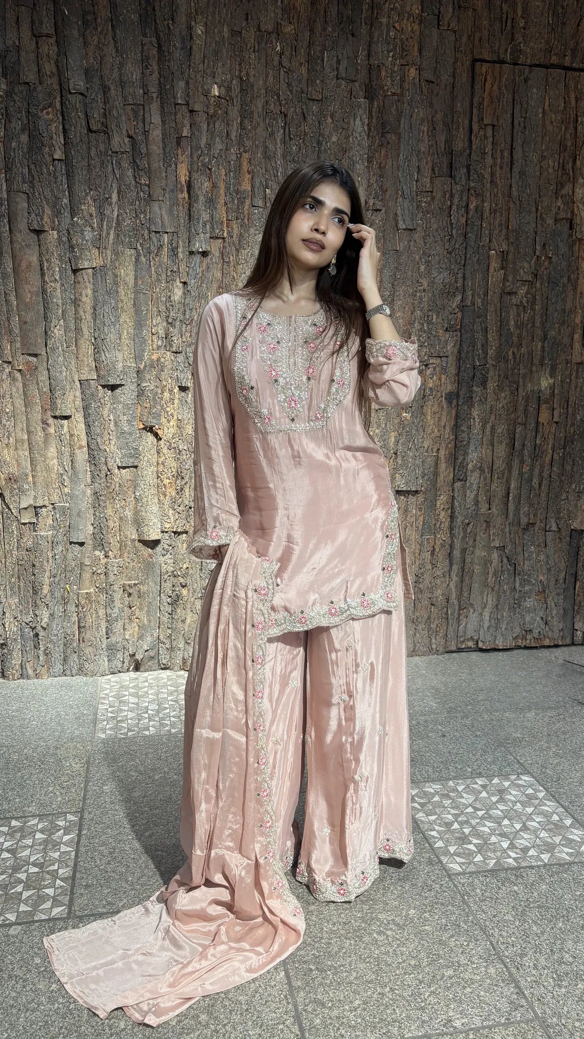 Front view of the onion pink plazo set, with fine thread embroidery across the yoke and the satin chinnon pooling at the hem.