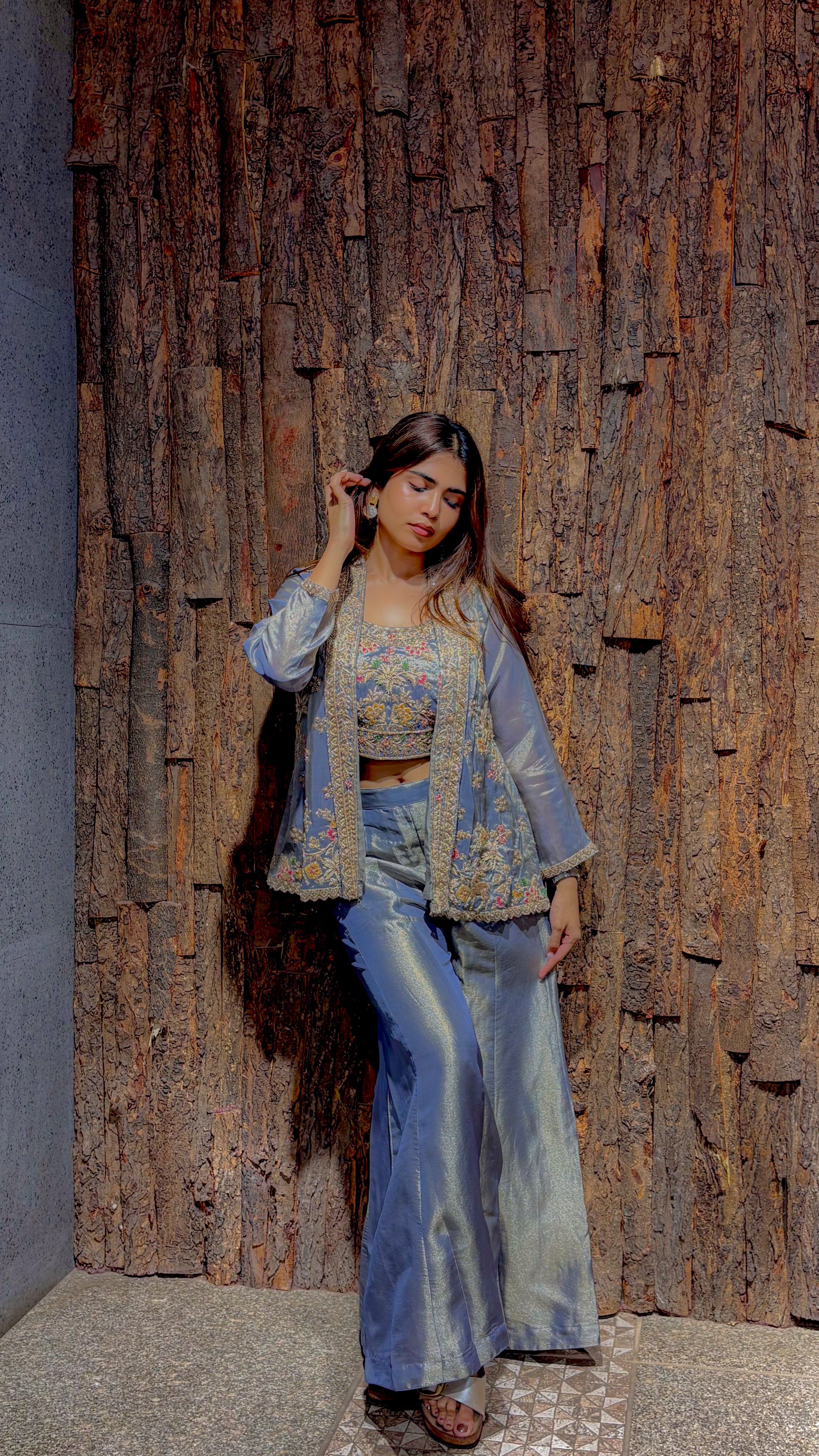 Pastel blue tissue jacket set, the long open jacket worked in heavy zari over an embroidered bustier and wide-leg trousers.