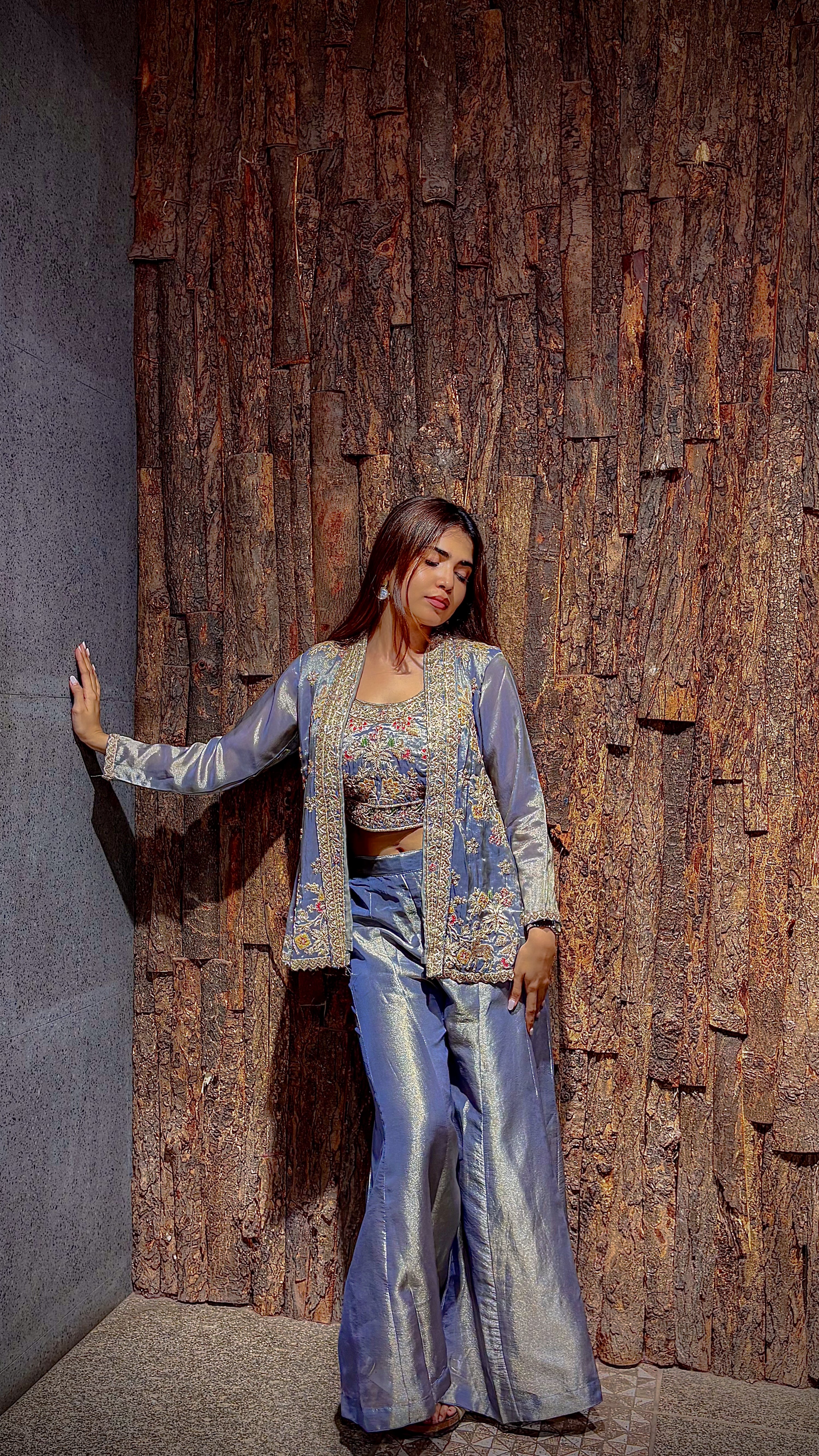 Full-length view of the pastel blue indo-western set, the tissue trousers falling straight and the jacket hanging open.