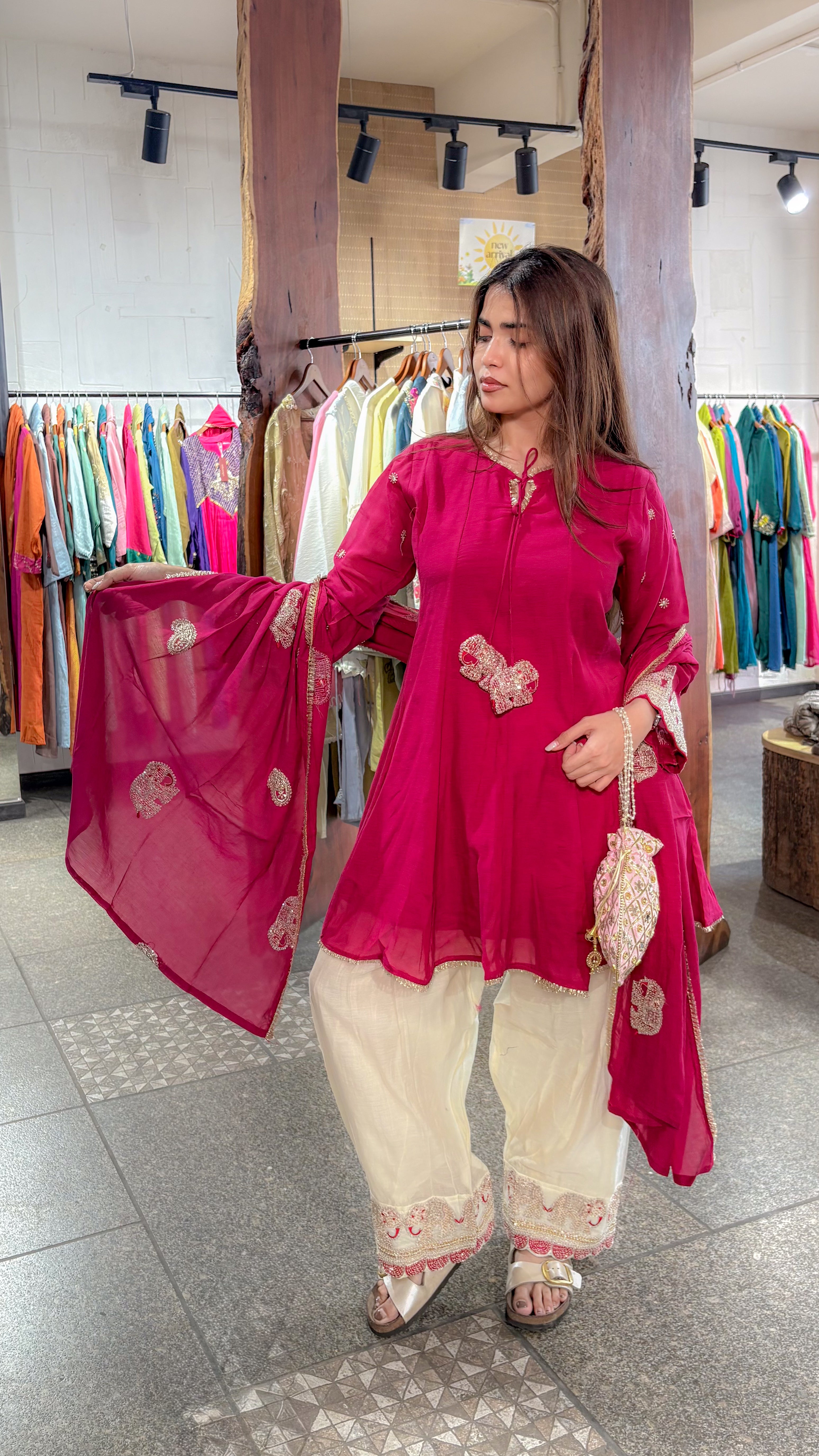 Side view of the rani frock set, showing the flared mul chanderi hem over the ivory plazo and its worked border.