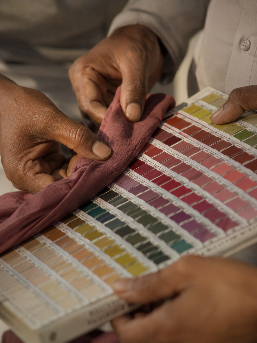 Person selecting a color swatch from a color chart